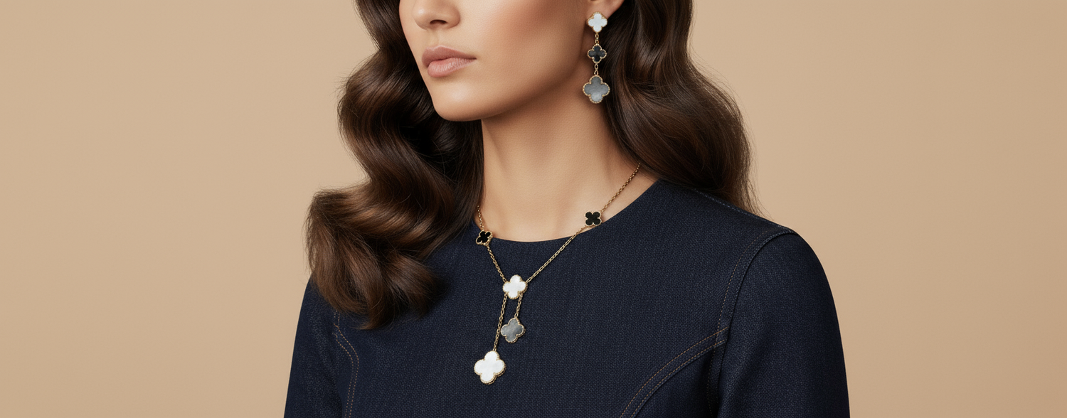 6 motif clover necklace and clover drop earrings on an elegant woman